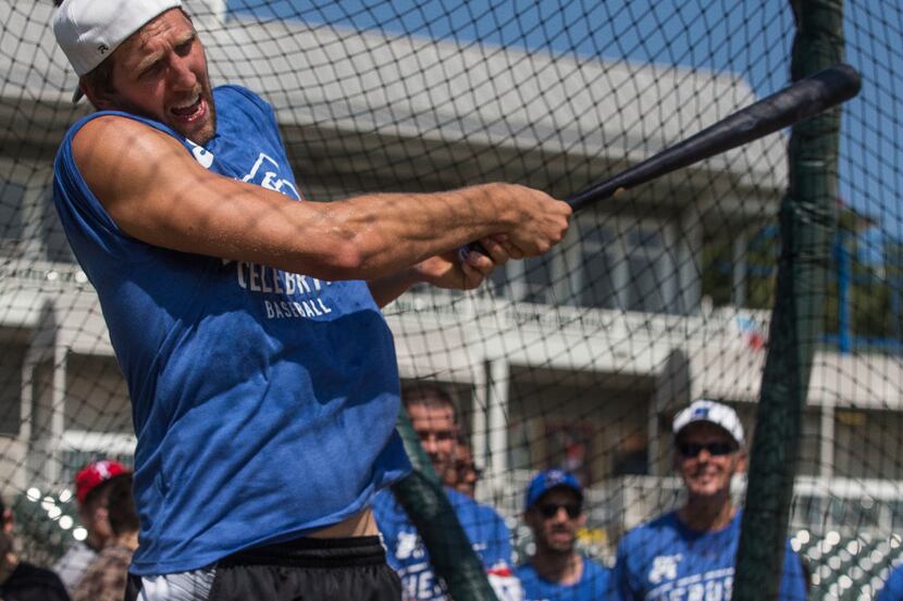 Dallas Mavericks forward Dirk Nowitzki swings at a pitch during training camp for his 2017...
