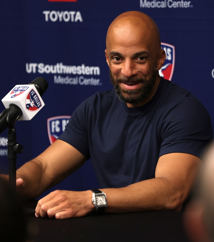 Peter Luccin, new FC Dallas interim head coach, converses with media members during a press...