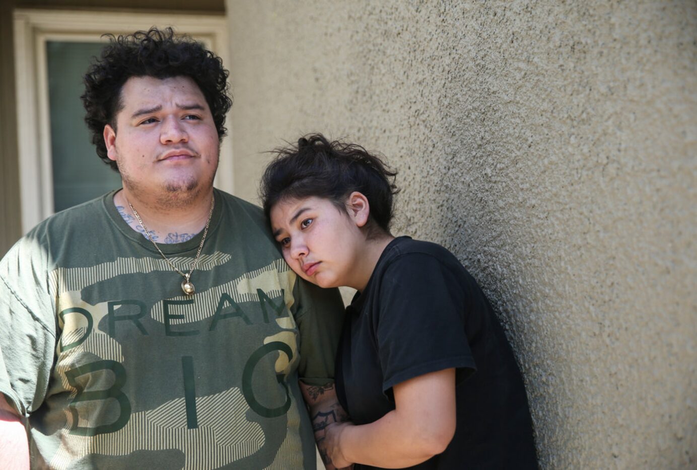 Audrey Flores (right) rests her head on the shoulder of her boyfriend, D'Marco Gonzalez, as...