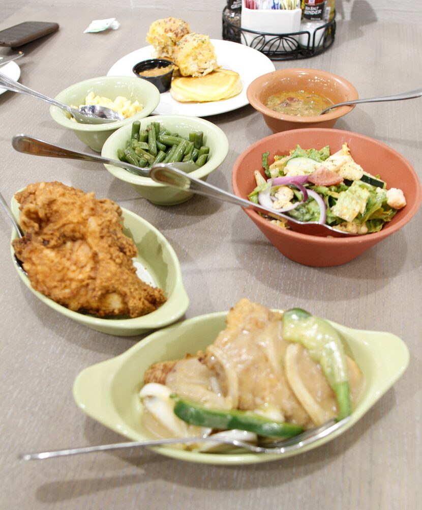 Fried pork chop and fried chicken with sides at Paula Deen's Family Kitchen in Fairview on...