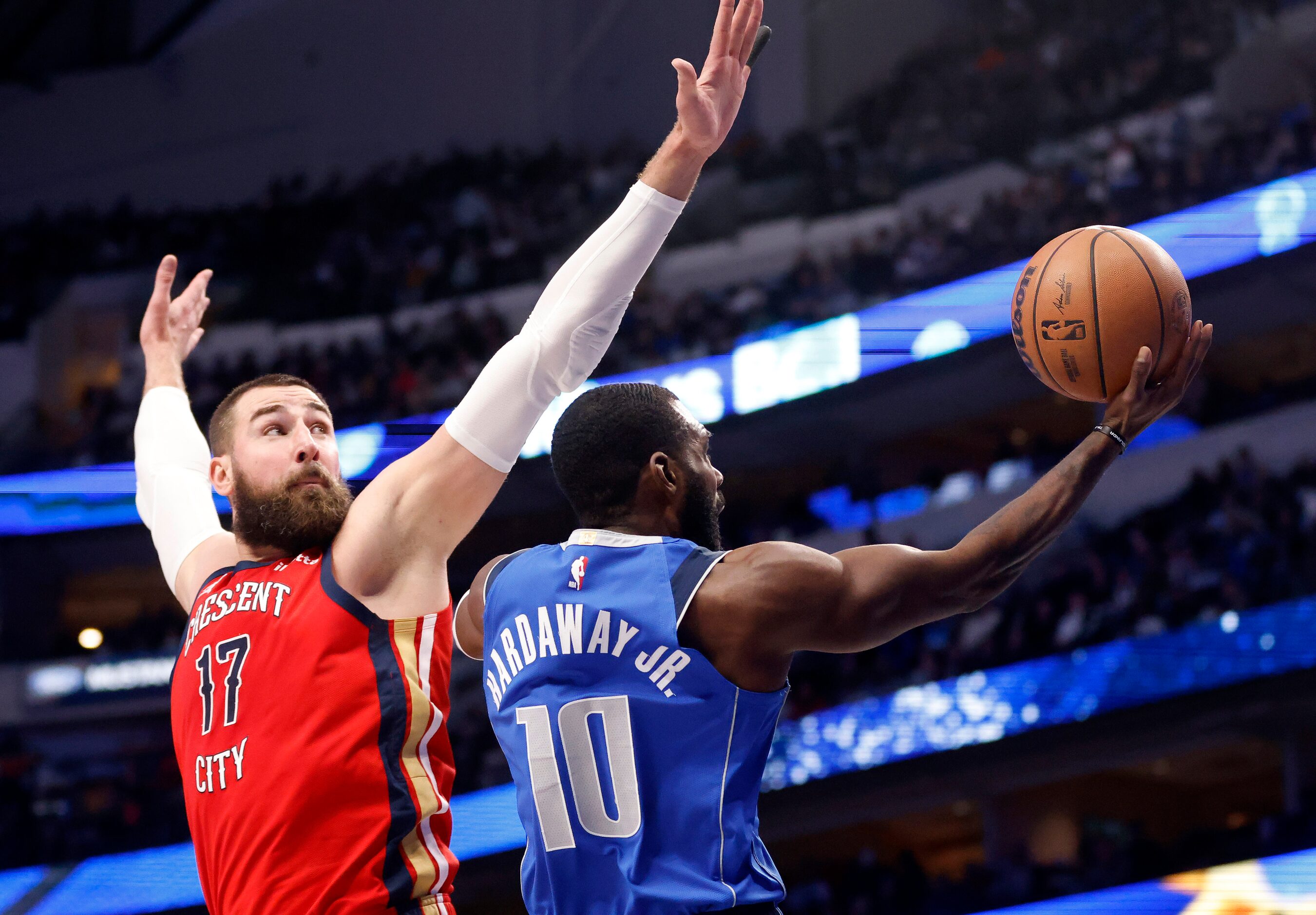 Dallas Mavericks forward Tim Hardaway Jr. (10) lays up a shot past the outstretched arms of...