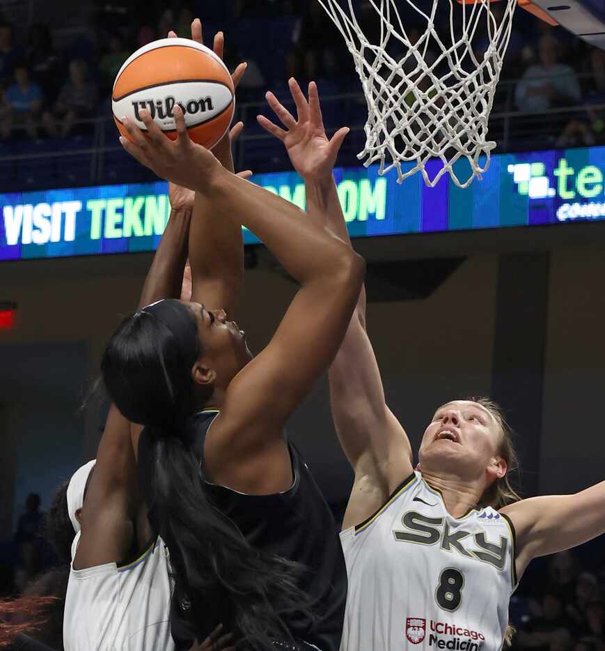 Dallas Wings center Tiera McCowan (7) scores two of her first half points as she is defended...