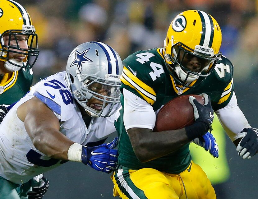 Dallas Cowboys defensive end Jack Crawford (58) reaches for Green Bay Packers running back...