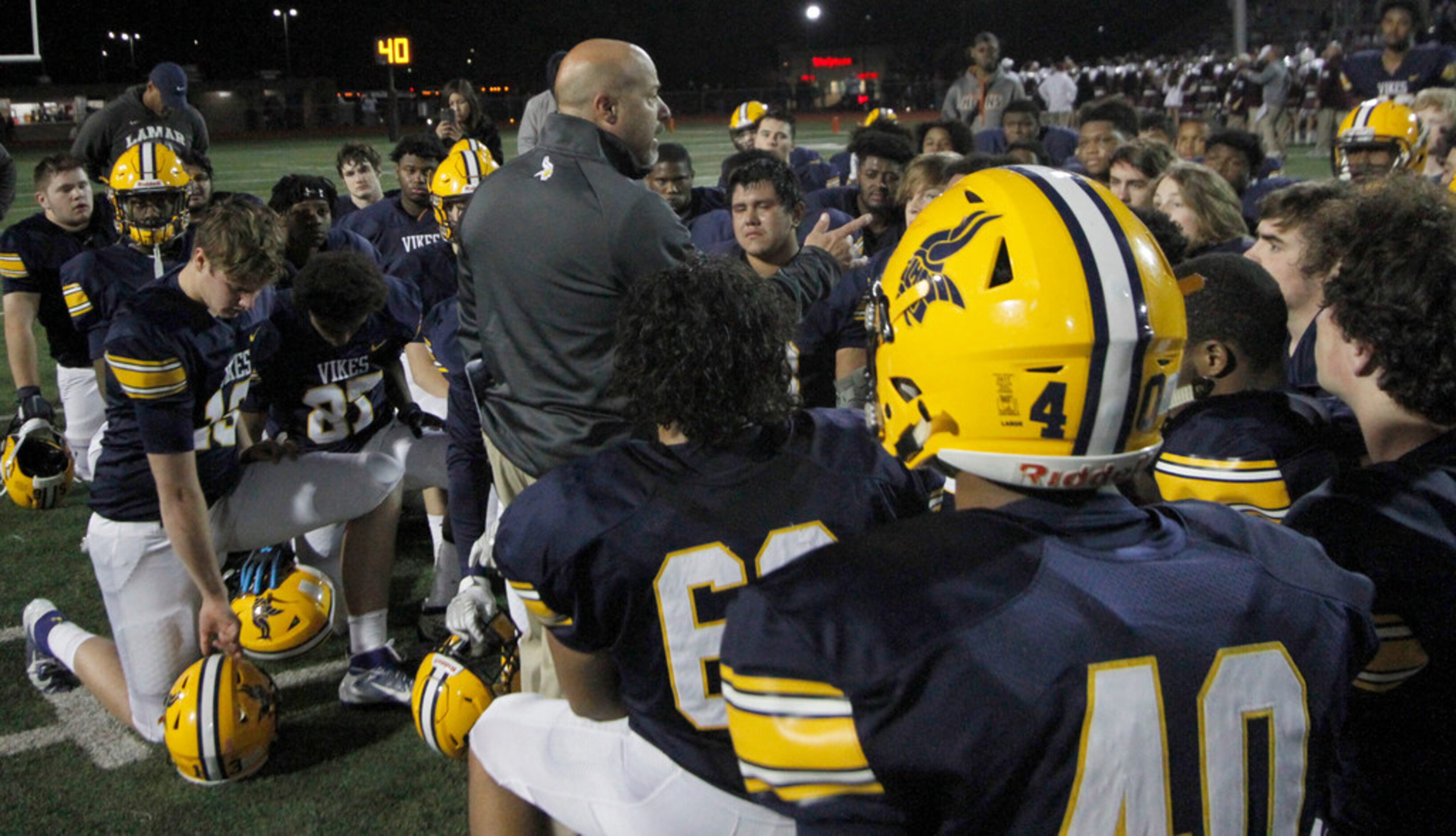 Arlington Lamar head coach Laban DeLay shares words of inspiration and encouragement to his...