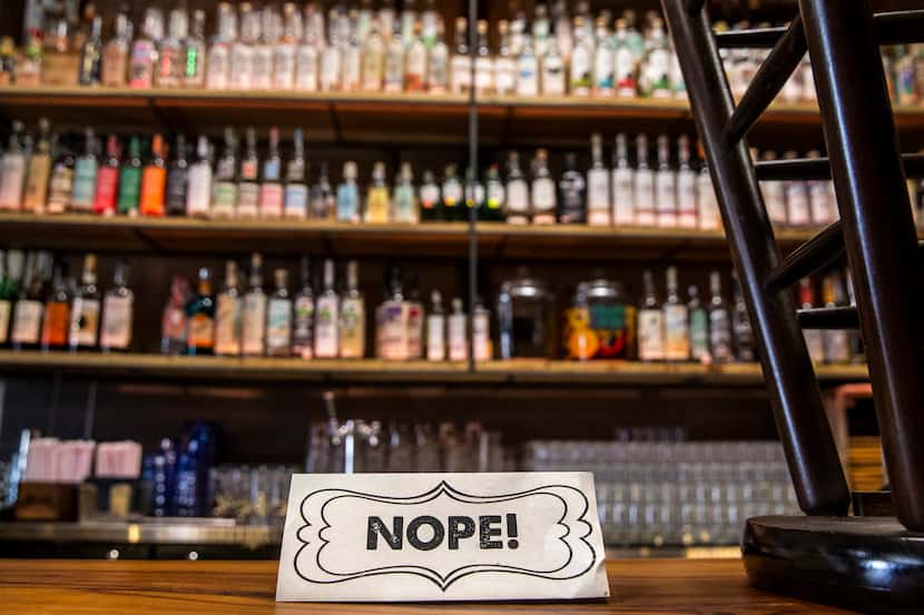 A sign reading ÒNOPE!Ó indicates social distancing measures put in place by the owners of...