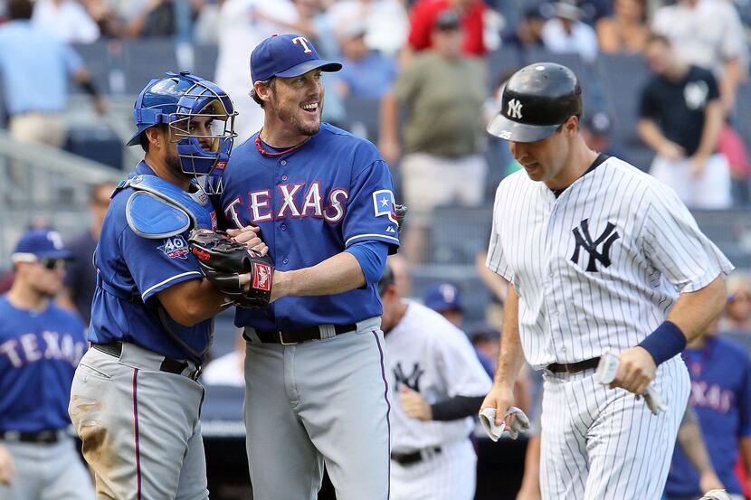 Joe Nathan and catcher Geovany Soto of the Texas Rangers celebrate their victory as Mark...