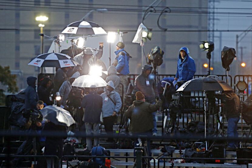 TV crews braved cold weather and a steady rain Friday before the Dealey Plaza ceremony...