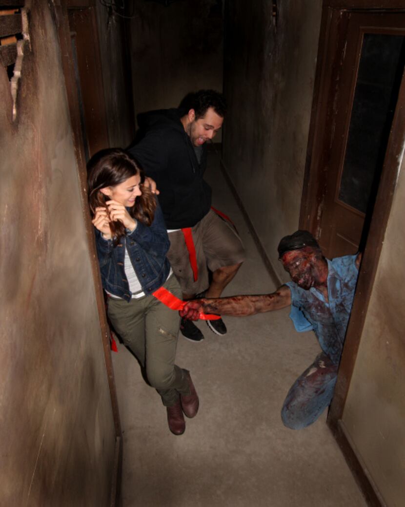 This August 2013 image provided by Shocktoberfest shows an actor portraying a zombie grabs a...
