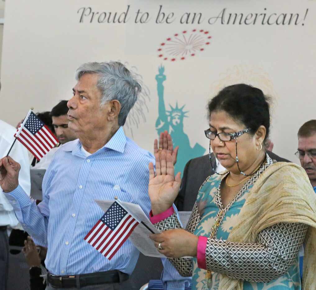 Mohammad Jameel and Shahnaz Parveen, both from Pakistan, take the oath of citizenship as...
