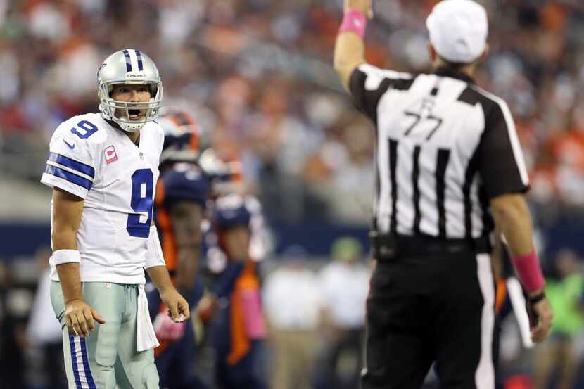 Dallas Cowboys quarterback Tony Romo (9) argues with referee Terry McAulay (77) after a play...