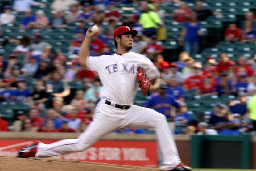 Texas Rangers' Yu Darvish of Japan throws to the New York Mets during a baseball game,...