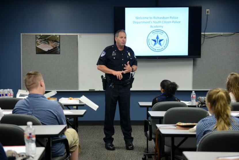 
Community liaison officer Lee Rhinebarger with the Richardson Police Department speaks to...