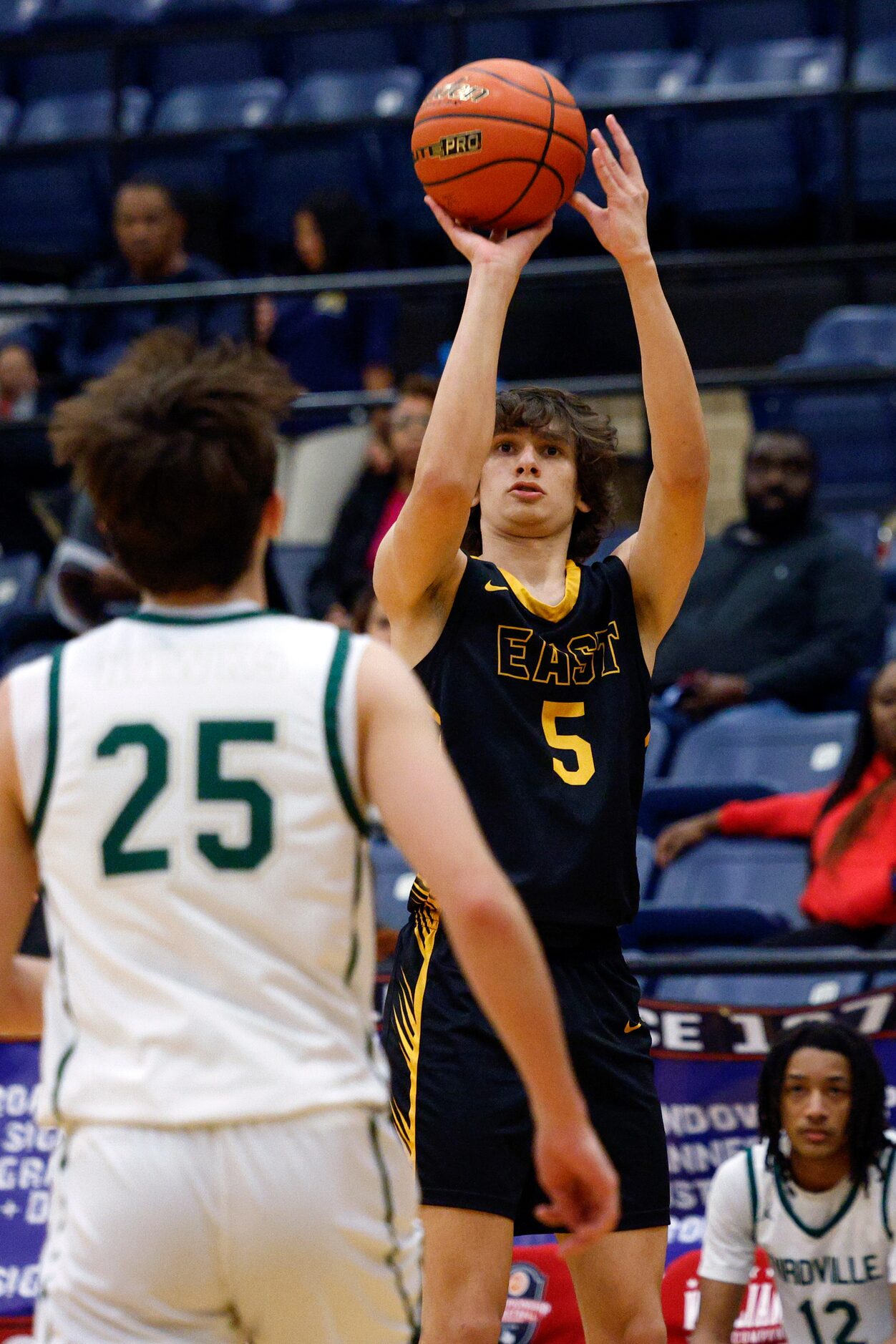 Plano East wing Ethan Moss (5) shoots over Birdville guard Niko Lucero (25) during the first...