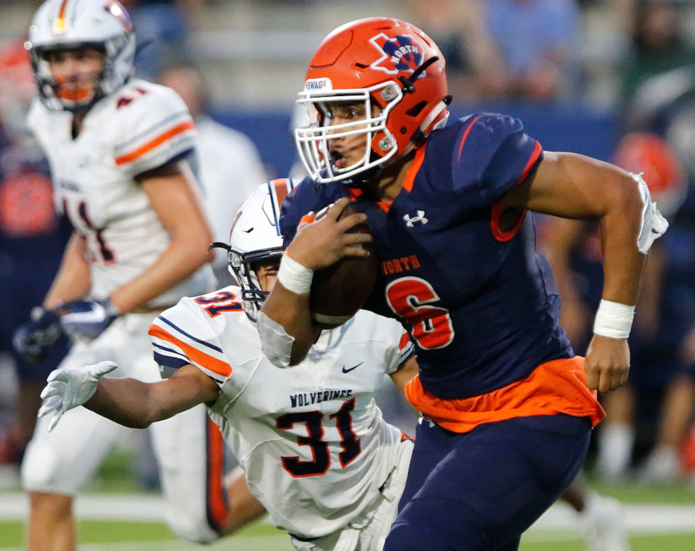 McKinney North High School running back Emmanuel Fincher (6) eludes Wakeland High School...