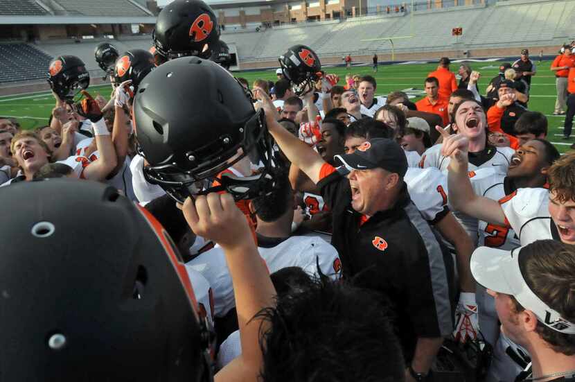 Rockwall head coach Rodney Webb celebrates with the team after they defeated Naaman Forest...