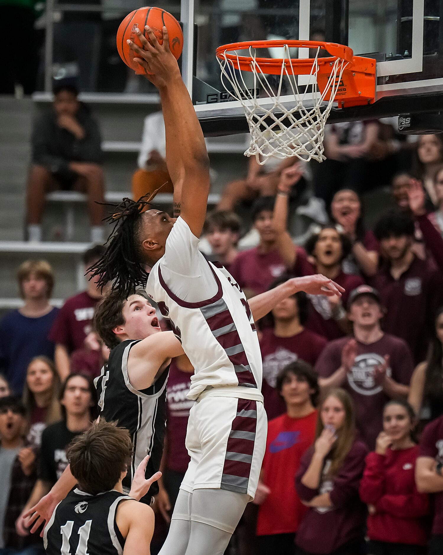 Plano forward Nikk Williams (22) dunks the ball past Denton Guyer forward Ethan Etter (5)...