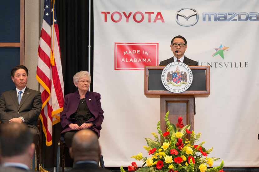 Akio Toyoda, right, Toyota Motor Corp., speaks as Alabama Gov. Kay Ivey, center, Masamichi...