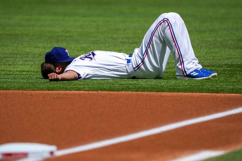 Texas Rangers shortstop Corey Seager stretches before the Rangers home opener against the...