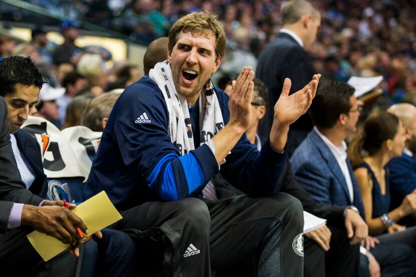 Dallas Mavericks forward Dirk Nowitzki (41) cheers from the bench /during the first quarter...