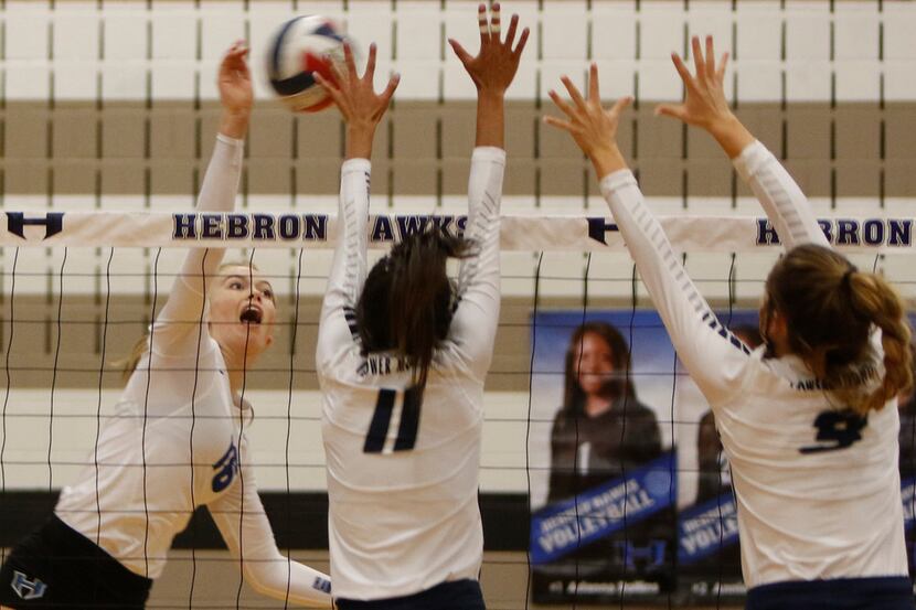 Hebron's Emma Clothier (16) scores a point over the defense of Flower Mound's Sydnee Johnson...