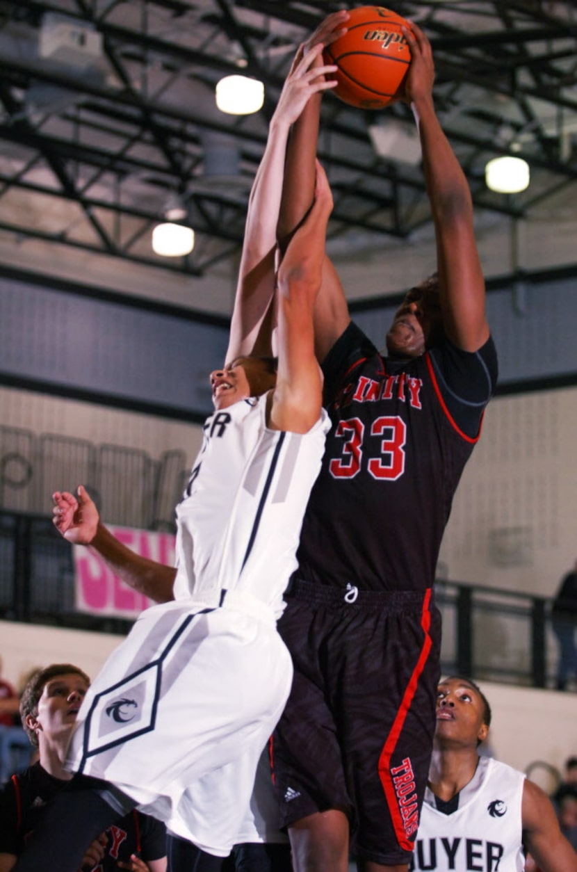 Guyer junior Kason Kilgore (22) can't get to a rebound against Euless Trinity senior Myles...