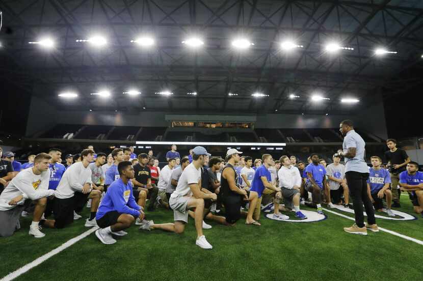Nike football's Brandon Roby talks with Frisco High School's football players before they...