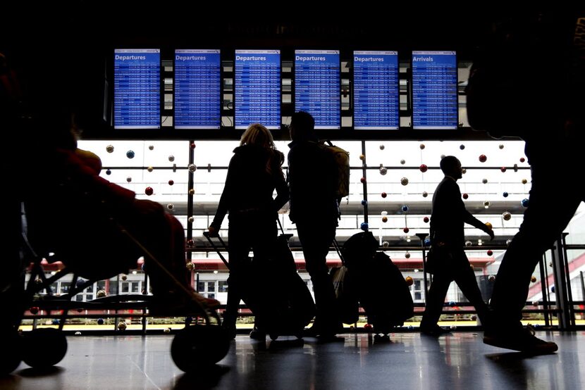 In this Nov. 29, 2015, file photo, travelers walk to their gates at O'Hare International...