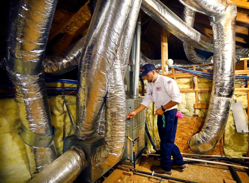 Berkey's technician Brandon Cronkhite checks the temperature of the air being pumped from a ...