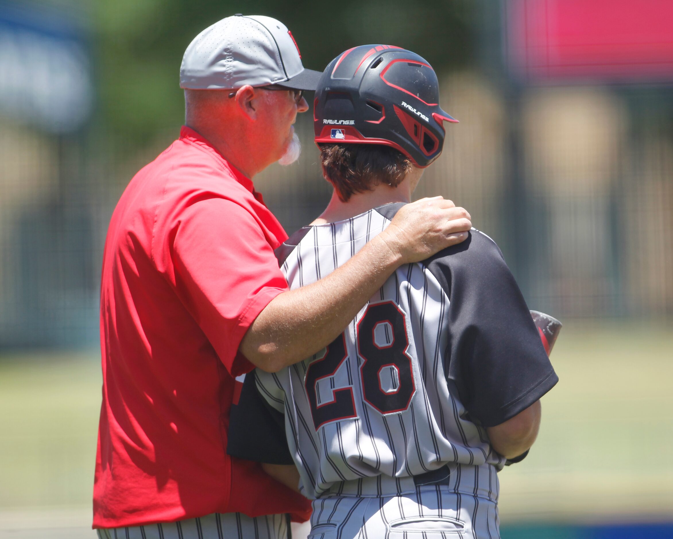 Rockwall Heath head coach Greg Harvey shares some strategy advice with JD Webb (28) during a...