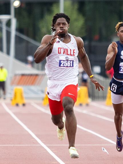 Pierre Goree of Duncanville, center, sprints to the finish line at the UIL Track & Field...