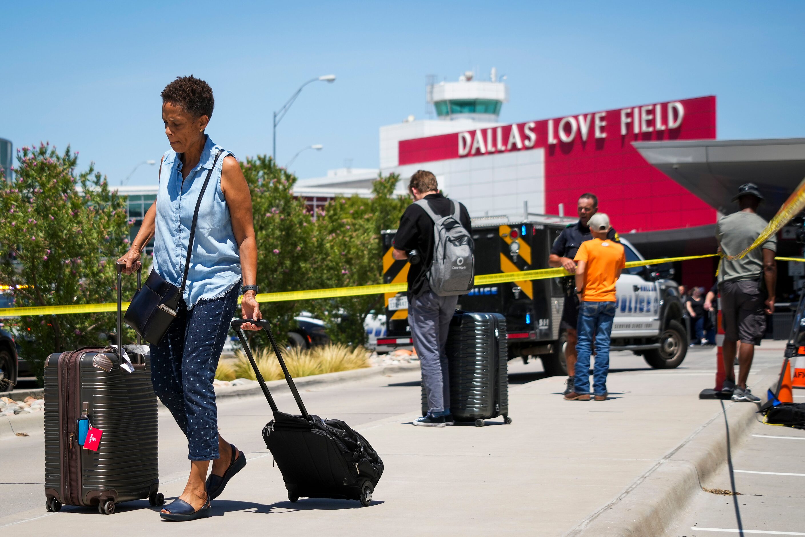 Passengers are directed away from the terminal at Dallas Love Field Airport on Monday, July...