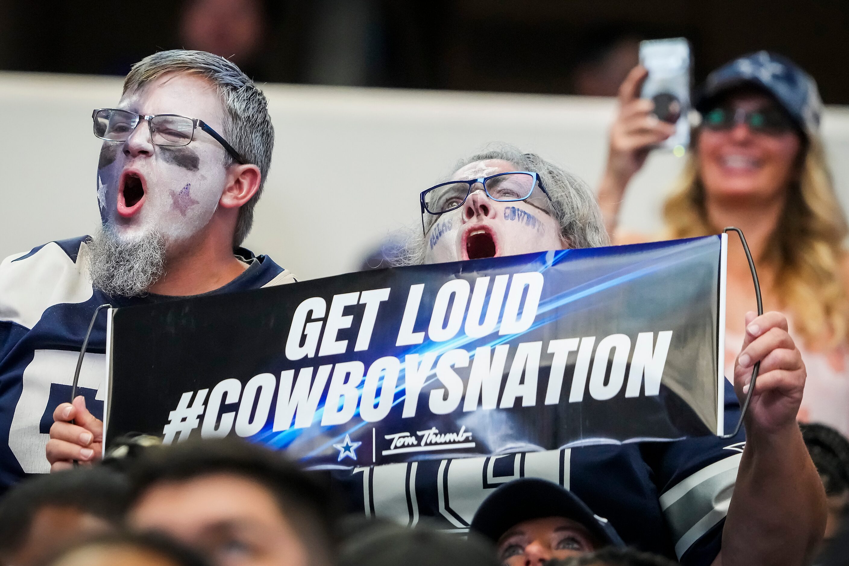 Dallas Cowboys fans celebrate a Cowboys score during the third quarter of an NFL football...