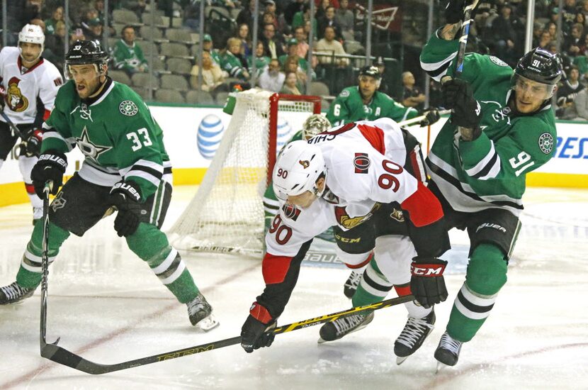 Dallas' Tyler Seguin (91) checks Ottawa's Alex Chiasson (90) in the second period during the...