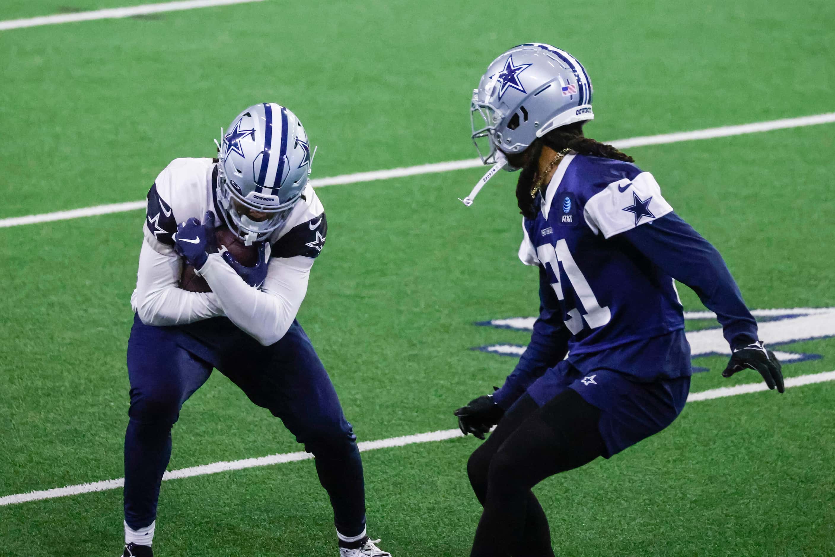 Dallas Cowboys running back Malik Davis (left) defends against cornerback Stephon Gilmore...