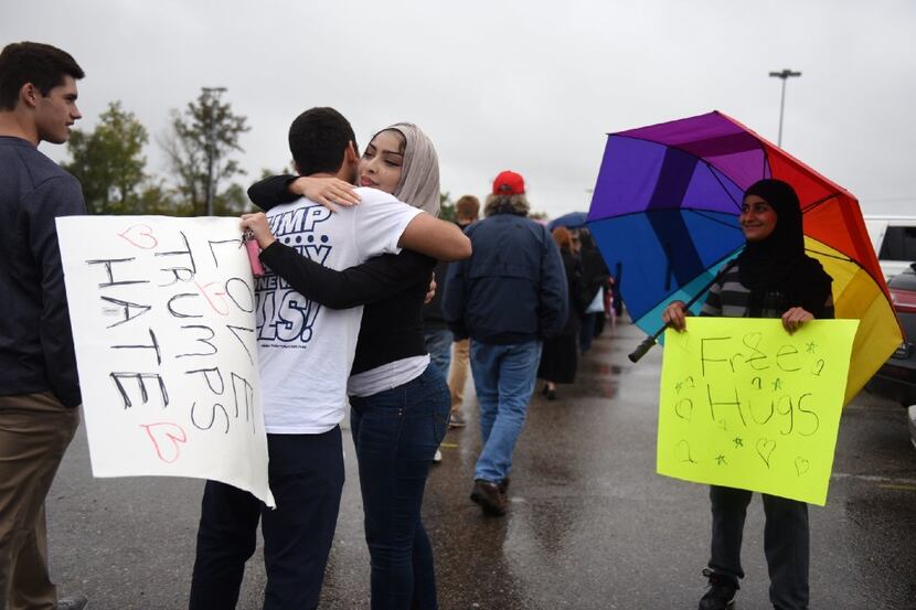 "We're here to spread love," said (left) Hajer Sbehawi, 25 of Detroit, after hugging Donald...