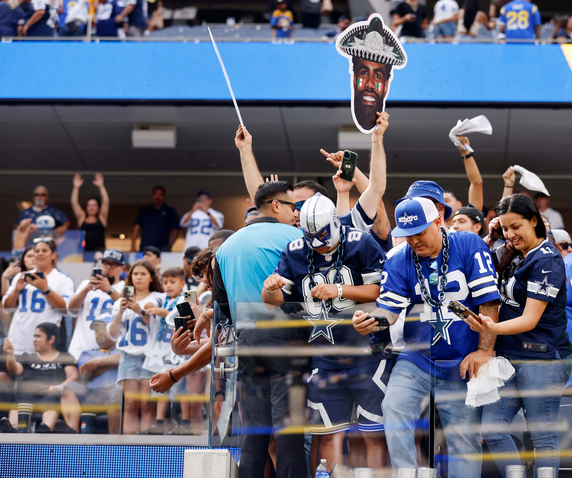 Dallas Cowboys fans cheer the players as they leave the field following a loss to the Los...