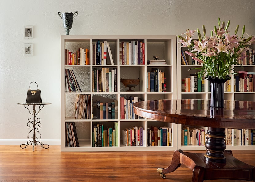 In the living space turned entryway, Windle paired Ikea bookshelves with a Regency-period...