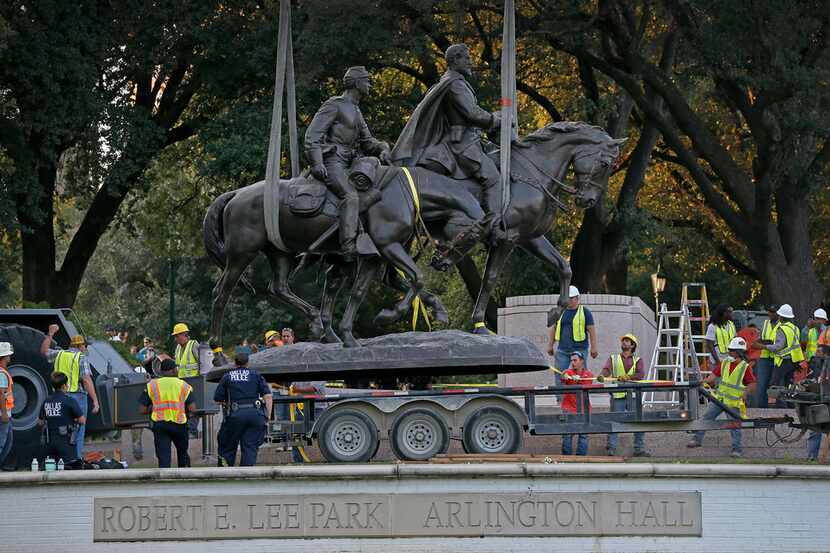 The Robert E. Lee statue is put in the back of a trailer truck at Robert E. Lee Park in...