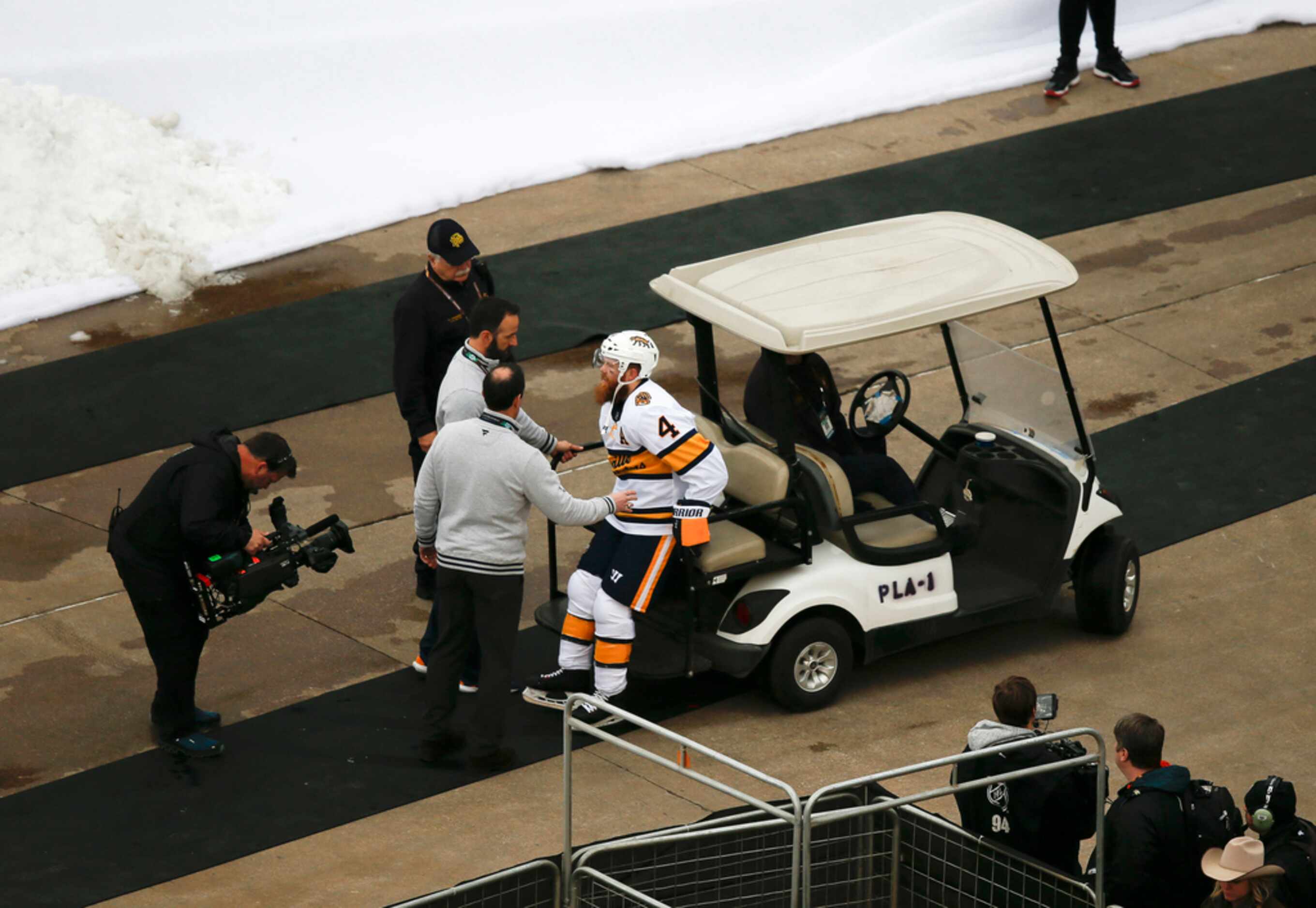 Nashville Predators defenseman Ryan Ellis (4) is helped off the ice after being injured...