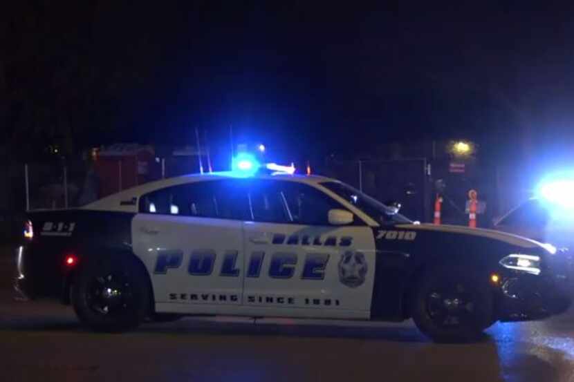 Dallas police gather at the scene of an auto-pedestrian crash Wednesday night on Polk Street...