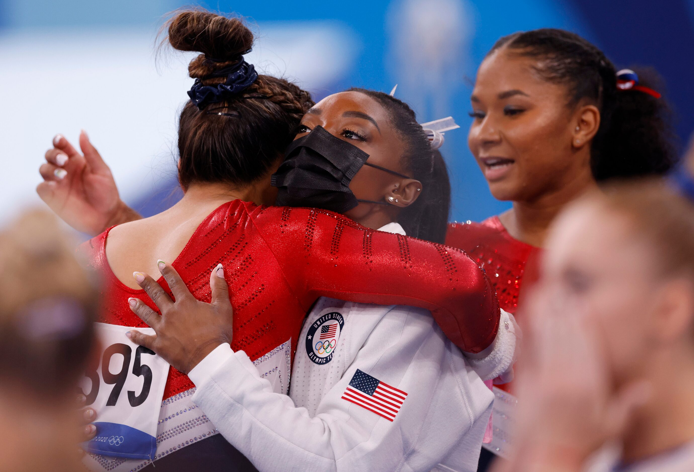 USA’s Simone Biles hugs Sunisa Lee after she competed in the uneven bars during the artistic...