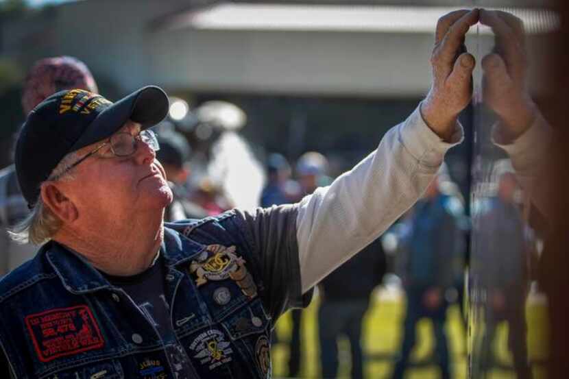 
Vietnam veteran Earl Goodwin of Italy, Texas, traces his fingers across the name of a...