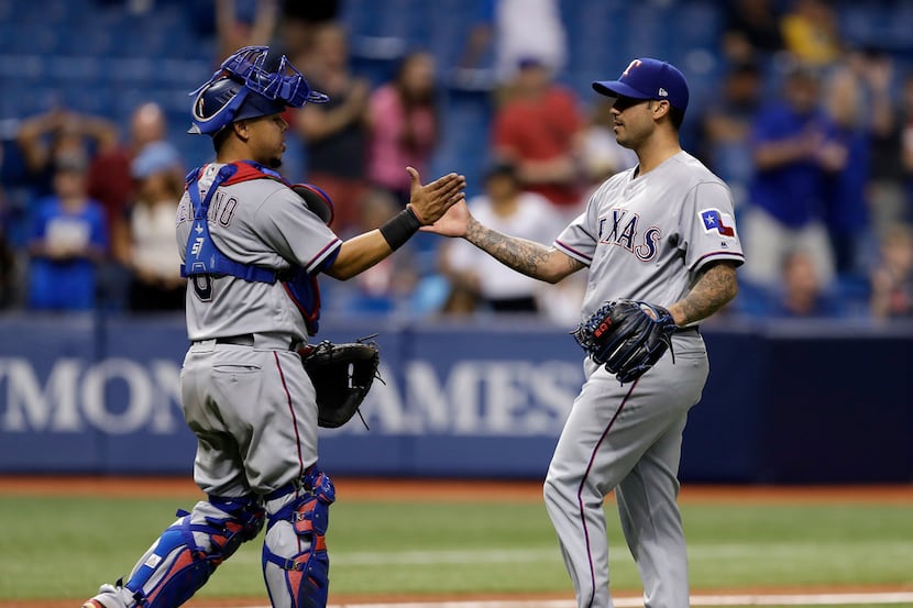 Texas Rangers catcher Juan Centeno, left, celebrates with relief pitcher Matt Bush after the...