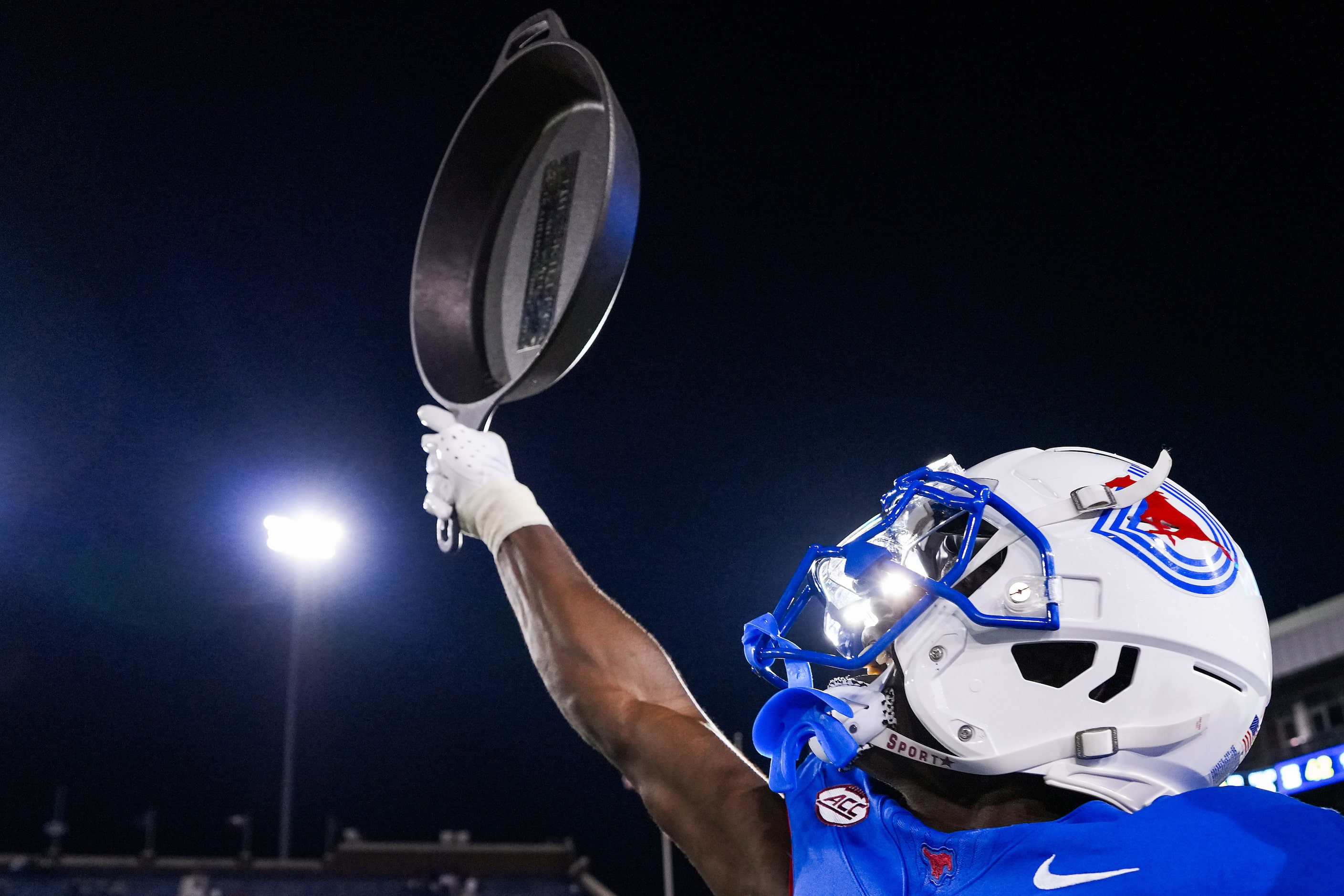 SMU wide receiver Jordan Hudson raises the Iron Skillet trophy after a 66-42 victory over...