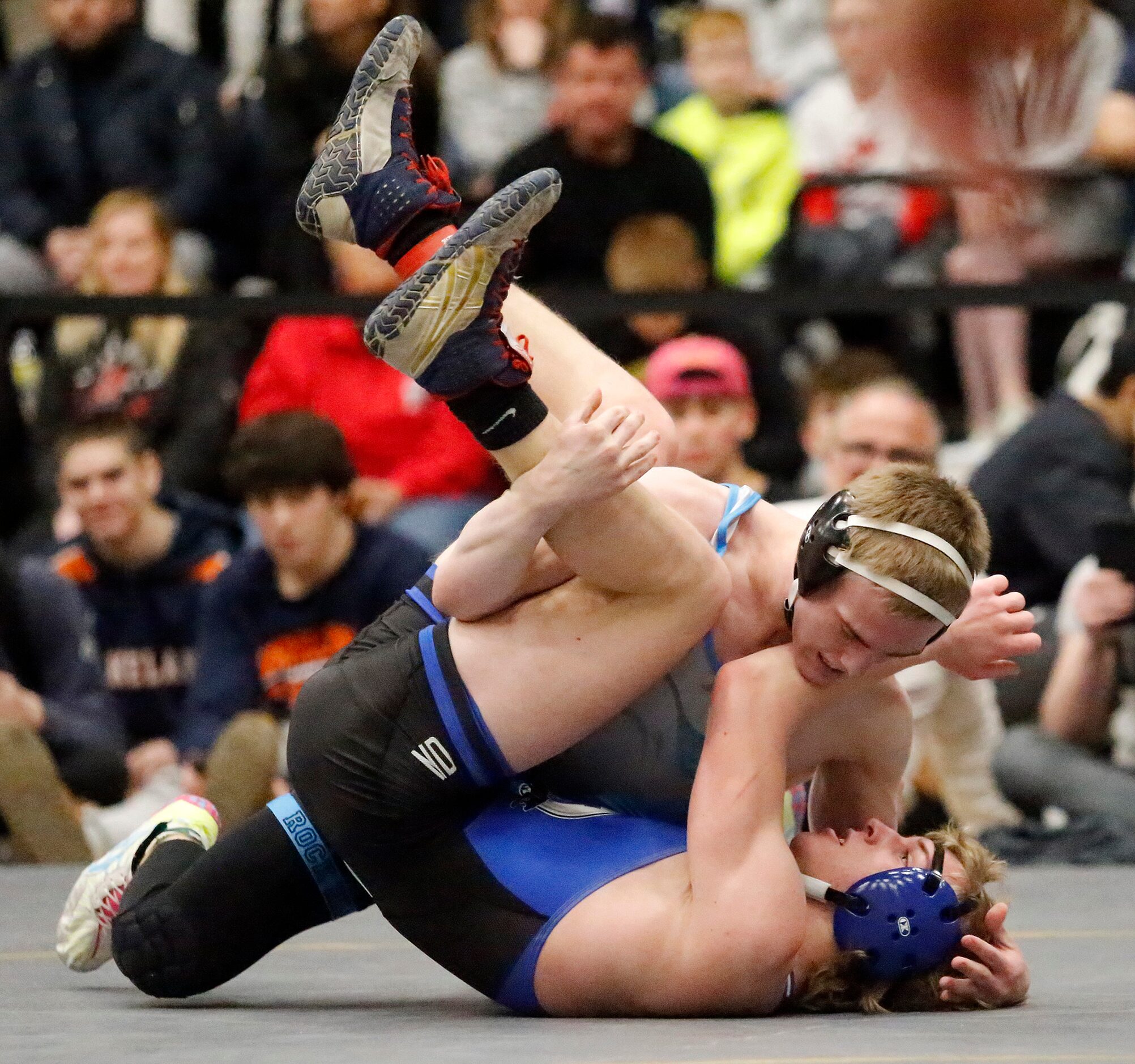 Xavier Jukes (top) of Prosper Rock Hill High School tries to pin Nicholas Cilli of...