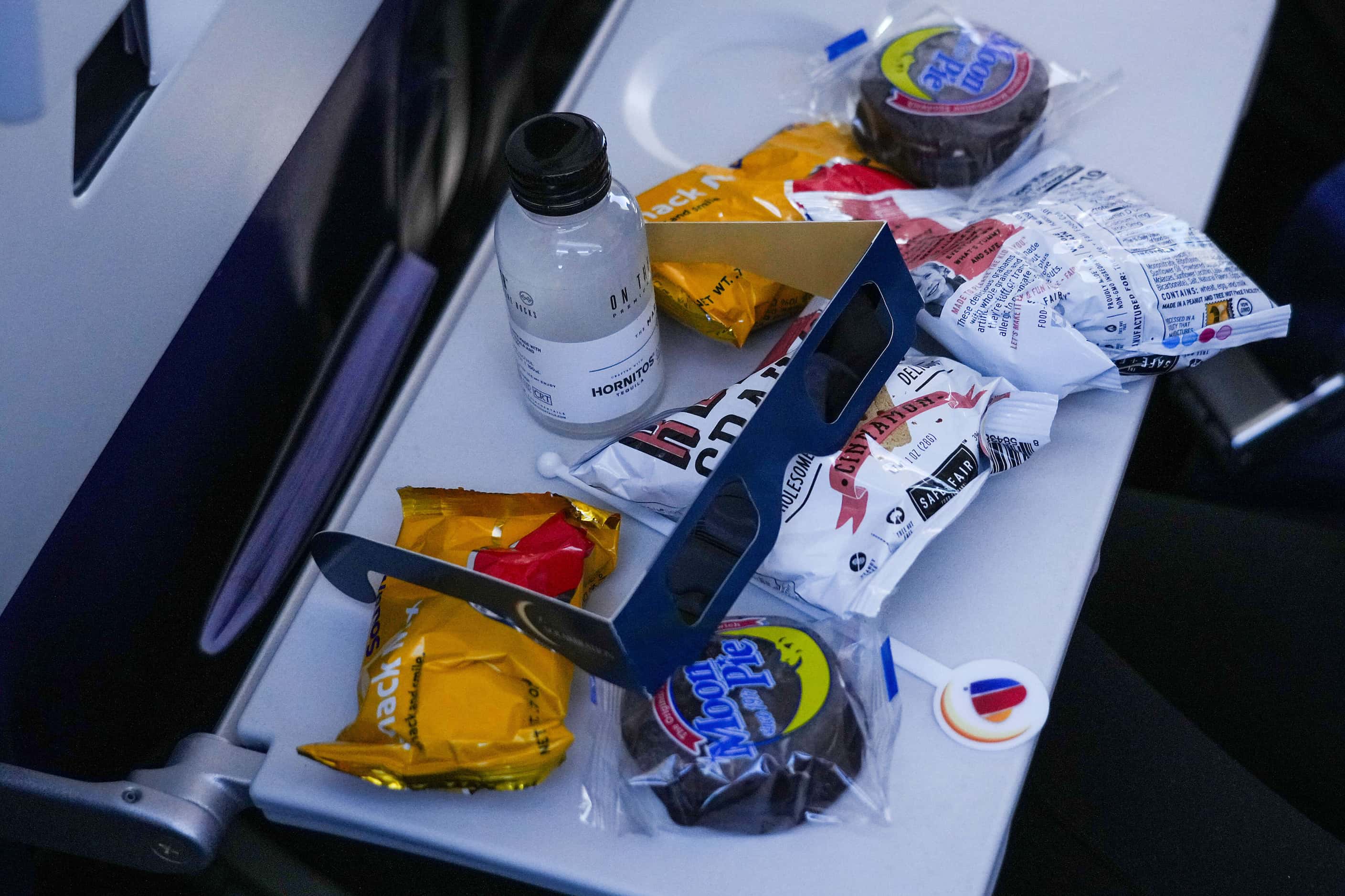 Eclipse glasses and Moon Pies on a passenger’s tray table on Southwest flight #1252 from...