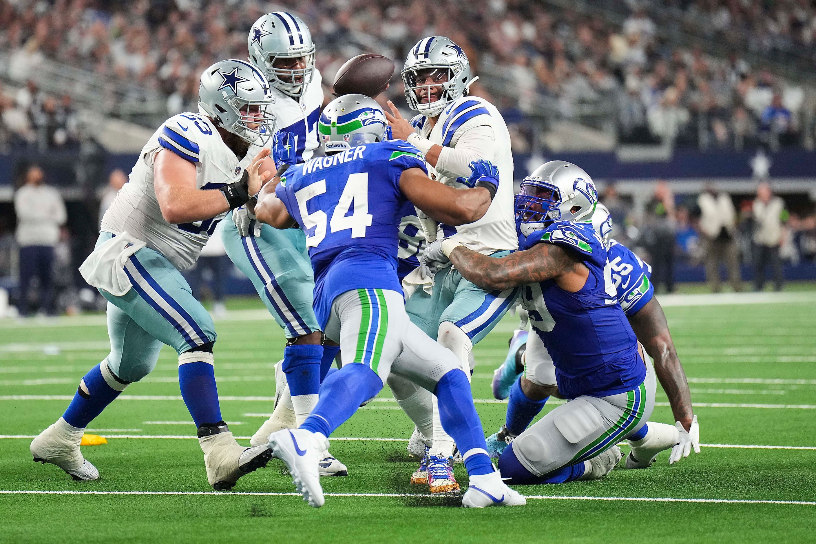 Dallas Cowboys quarterback Dak Prescott (4) is sacked by Seattle Seahawks defensive end...