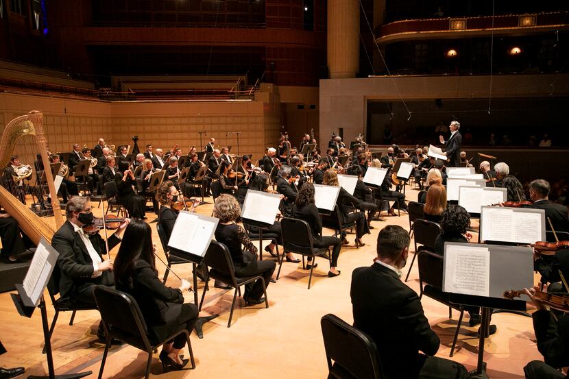 A wide shot of the Dallas Symphony Orchestra performing in the Eugene McDermott Concert Hall...
