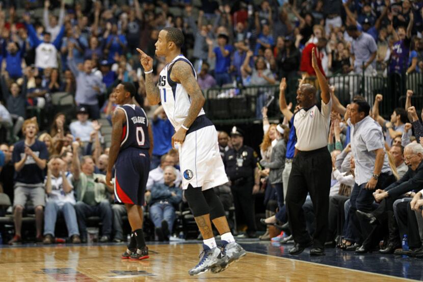 Fans hold up a sign expressing the desire for Deron Williams to become a Maverick during the...