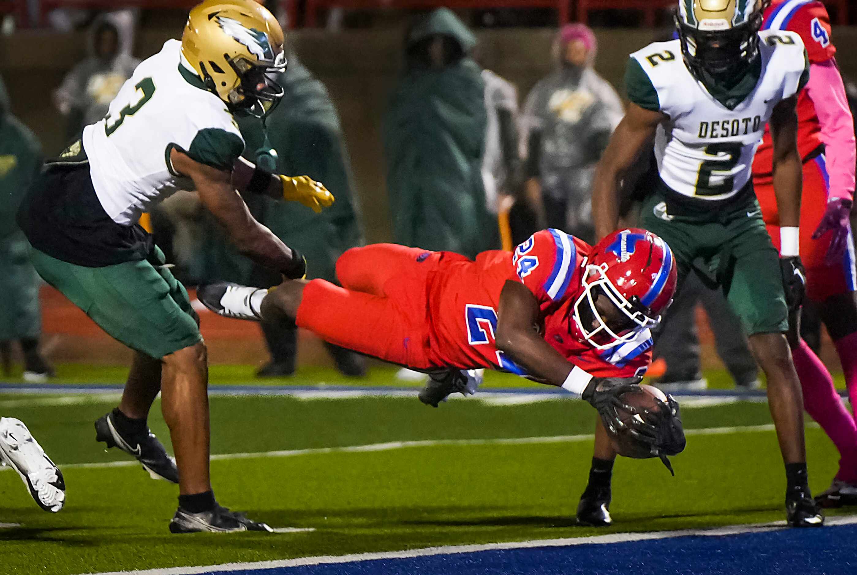 Duncanville’s Nehemiah Borner (24) dives in the the end zone for a touchdown past DeSoto...